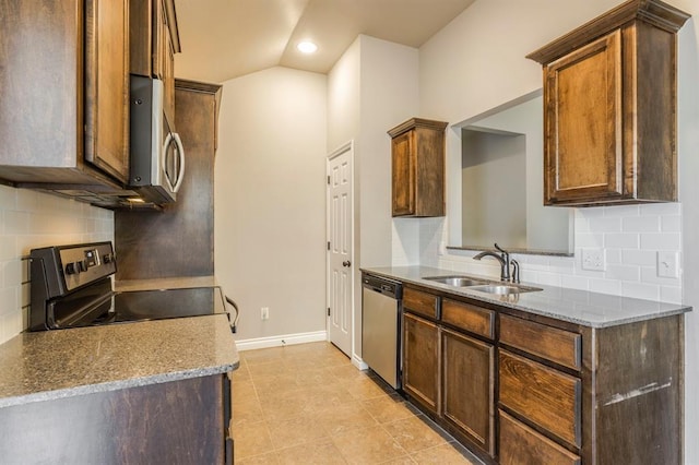 kitchen with stainless steel appliances, stone countertops, sink, and backsplash