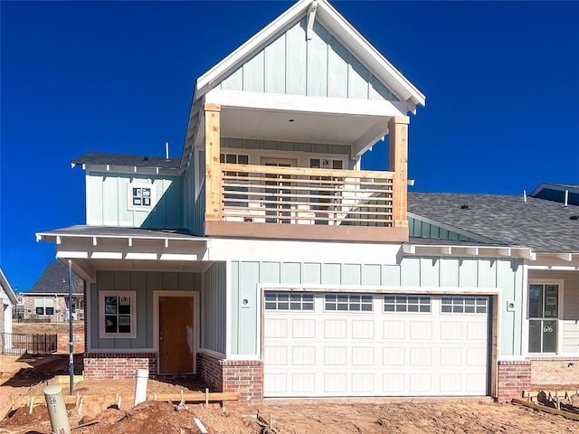 view of front of home featuring a balcony and a garage