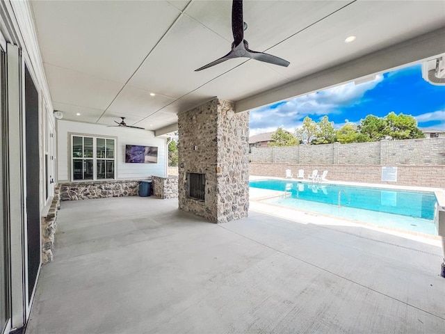 view of pool featuring a patio, a fenced backyard, and a ceiling fan