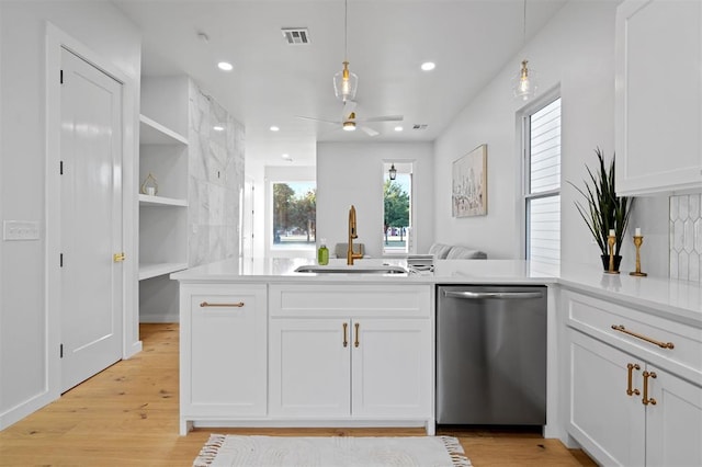 kitchen with white cabinets, pendant lighting, stainless steel dishwasher, and sink