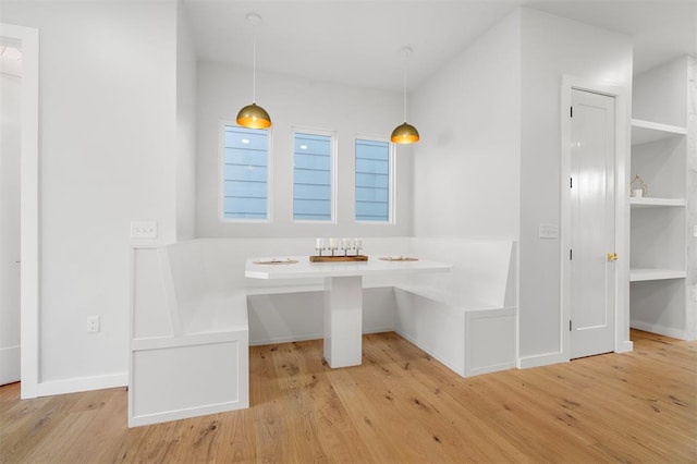 unfurnished dining area featuring light wood-type flooring