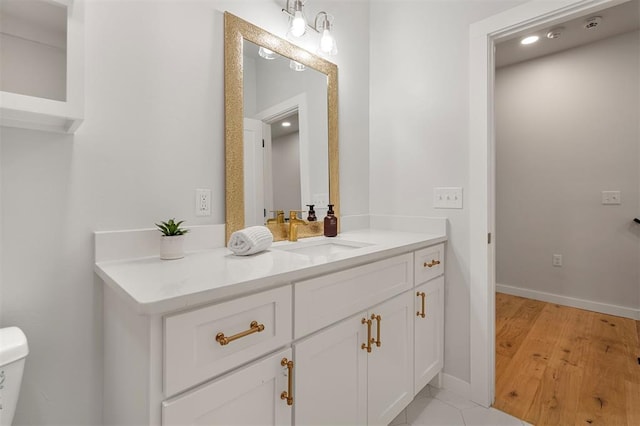 bathroom featuring toilet and vanity