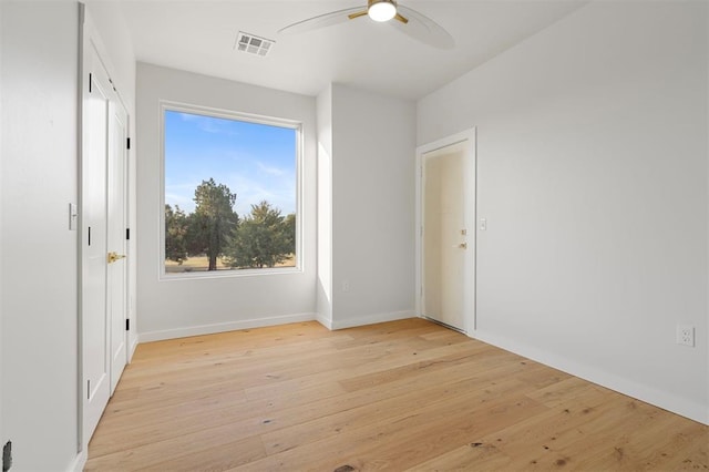 empty room with light hardwood / wood-style floors and ceiling fan