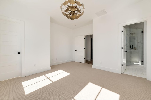 unfurnished bedroom with baseboards, connected bathroom, and light colored carpet