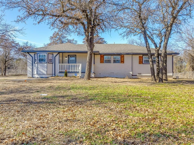 ranch-style house featuring a porch and a front yard