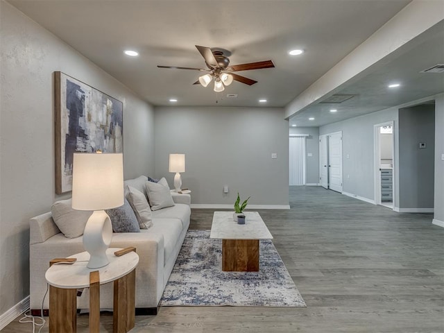 living room featuring ceiling fan and wood-type flooring