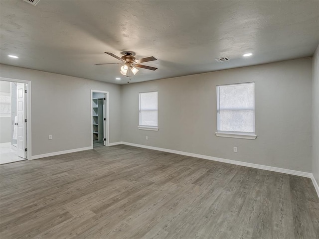 spare room featuring hardwood / wood-style floors and ceiling fan