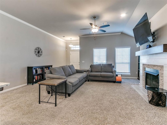 living room featuring light carpet, vaulted ceiling, ceiling fan, ornamental molding, and a fireplace