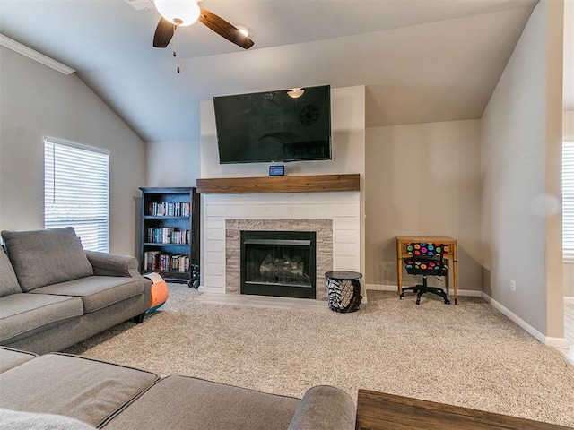 carpeted living room featuring a fireplace, crown molding, ceiling fan, and lofted ceiling