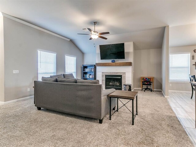 living room with ceiling fan, lofted ceiling, and ornamental molding