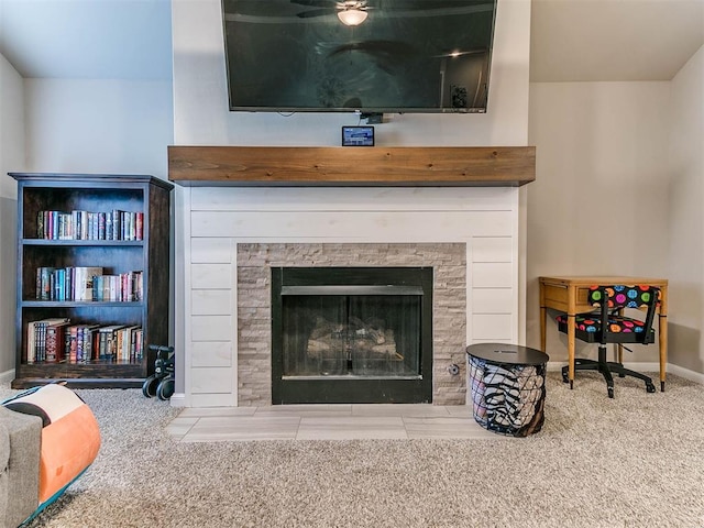 room details featuring carpet floors and a tiled fireplace