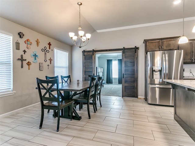 dining room with a barn door, a chandelier, and ornamental molding