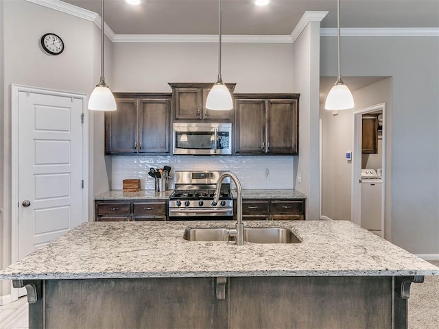 kitchen with tasteful backsplash, dark brown cabinetry, sink, and stainless steel appliances