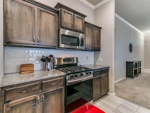 kitchen with dark brown cabinetry, decorative backsplash, and stainless steel appliances