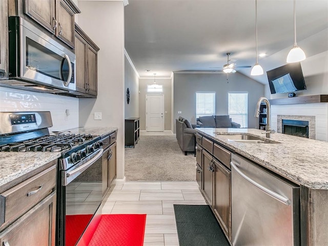 kitchen featuring sink, ceiling fan, decorative light fixtures, light colored carpet, and stainless steel appliances