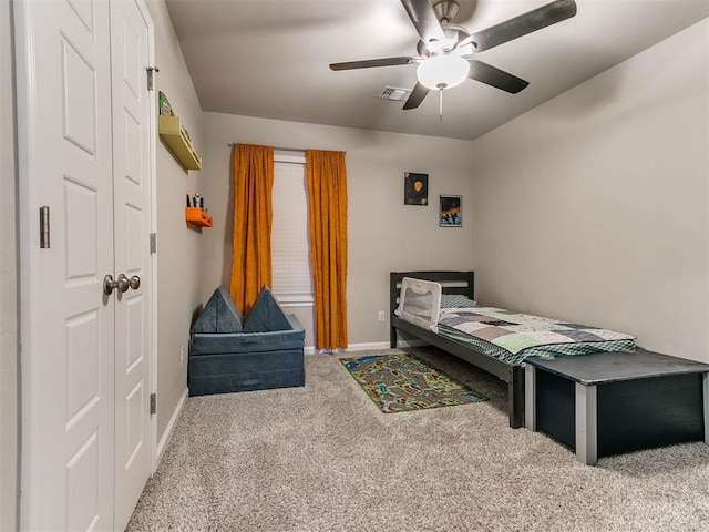 carpeted bedroom with a closet and ceiling fan