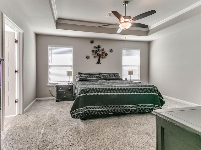 bedroom with carpet floors, a tray ceiling, ceiling fan, and crown molding