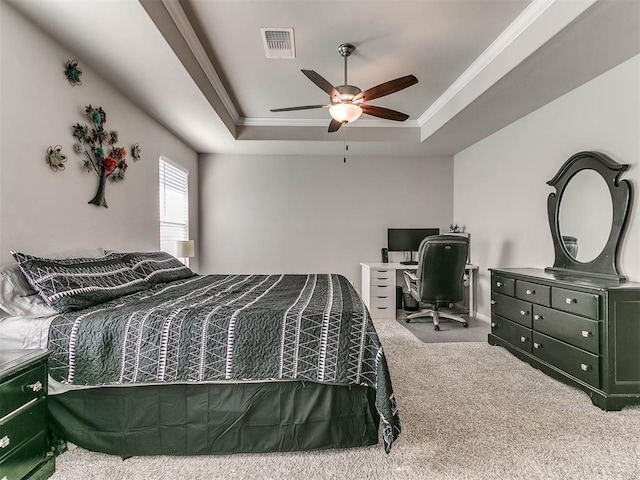 carpeted bedroom featuring a raised ceiling, ceiling fan, and crown molding