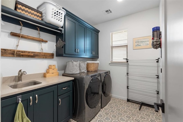 clothes washing area with visible vents, washer and clothes dryer, light tile patterned flooring, cabinet space, and a sink