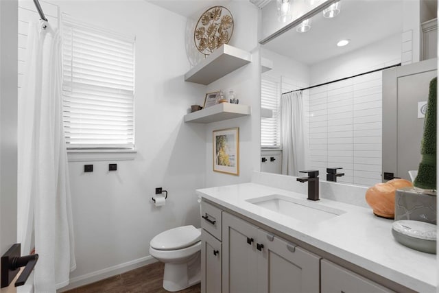 bathroom featuring toilet, curtained shower, wood finished floors, baseboards, and vanity