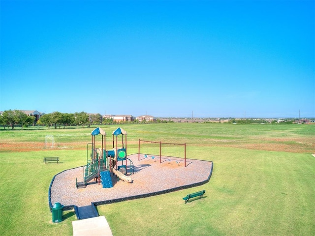 communal playground featuring a yard