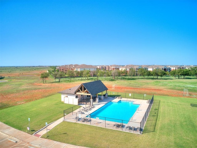 community pool featuring a gazebo, a patio, a lawn, and fence