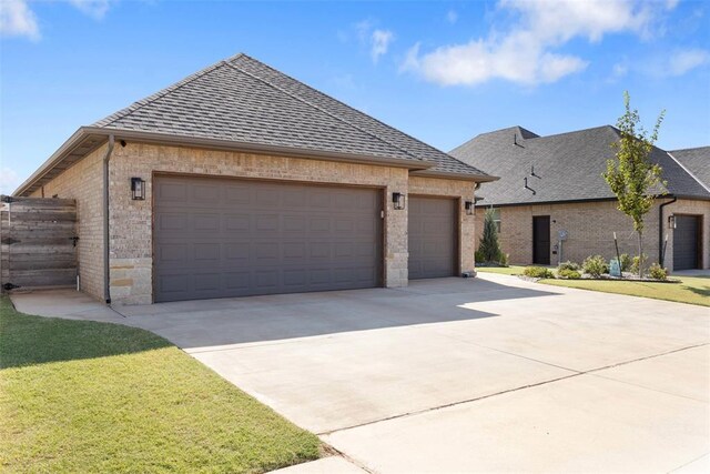 14704 Ashore Dr, Oklahoma City, OK 73142 - view of front of property featuring brick siding, a garage, concrete driveway, and a shingled roof