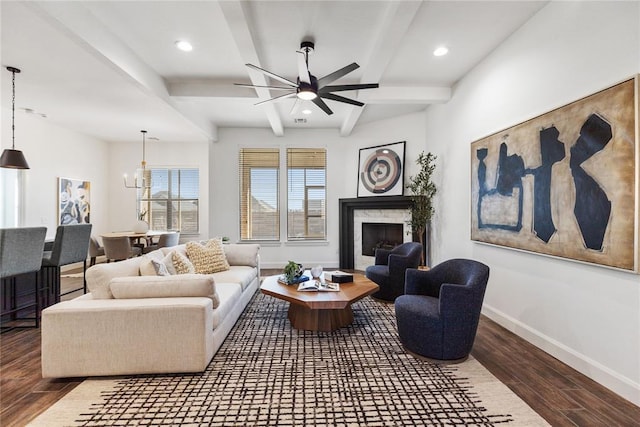 14704 Ashore Dr, Oklahoma City, OK 73142 - living room featuring wood finished floors, ceiling fan with notable chandelier, a high end fireplace, baseboards, and beamed ceiling