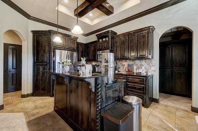 kitchen featuring stainless steel refrigerator with ice dispenser, dark brown cabinetry, dark stone counters, and a kitchen island