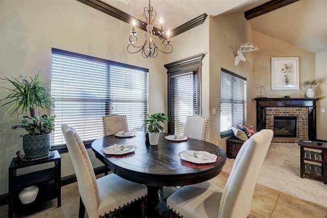 tiled dining area featuring a brick fireplace, vaulted ceiling with beams, ornamental molding, and an inviting chandelier