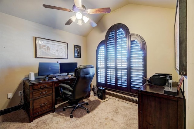 carpeted home office featuring ceiling fan and vaulted ceiling