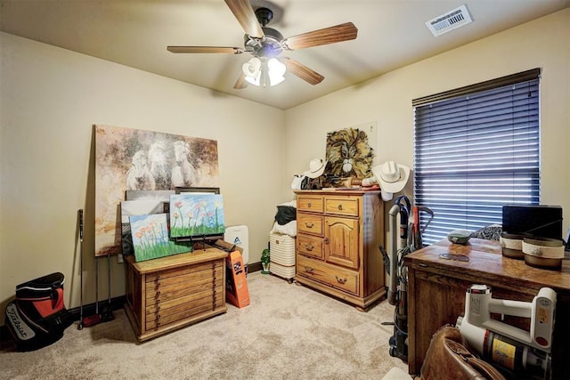 carpeted office space featuring ceiling fan