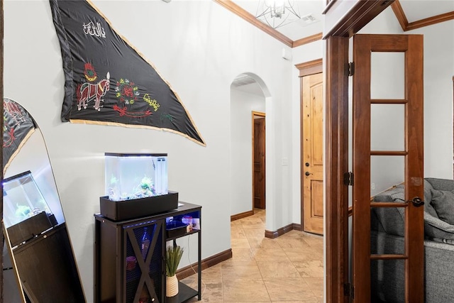 hallway with light tile patterned floors and crown molding