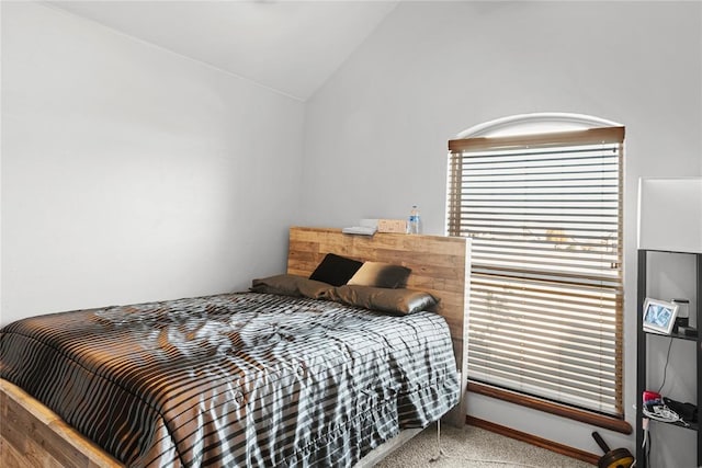 bedroom featuring lofted ceiling and carpet floors