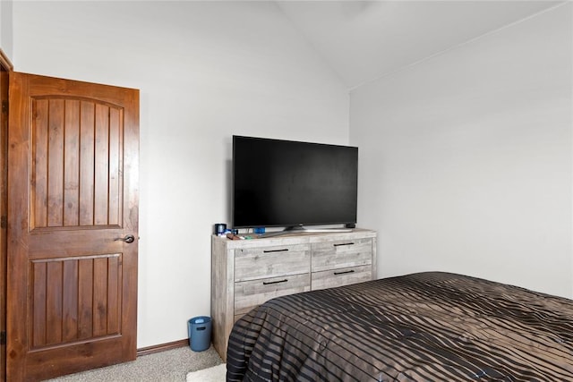 carpeted bedroom featuring lofted ceiling