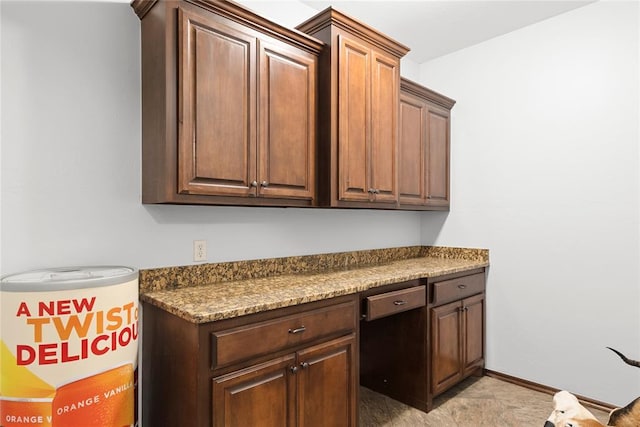 kitchen with built in desk and light stone counters