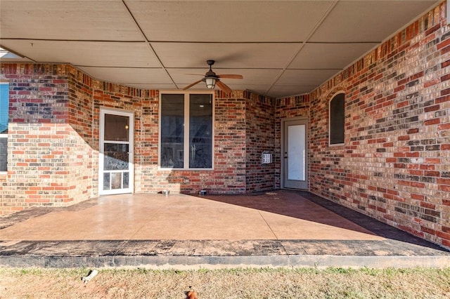 property entrance with ceiling fan and a patio area