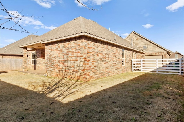 view of side of home featuring a yard