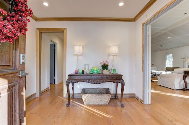 corridor featuring light hardwood / wood-style floors and ornamental molding