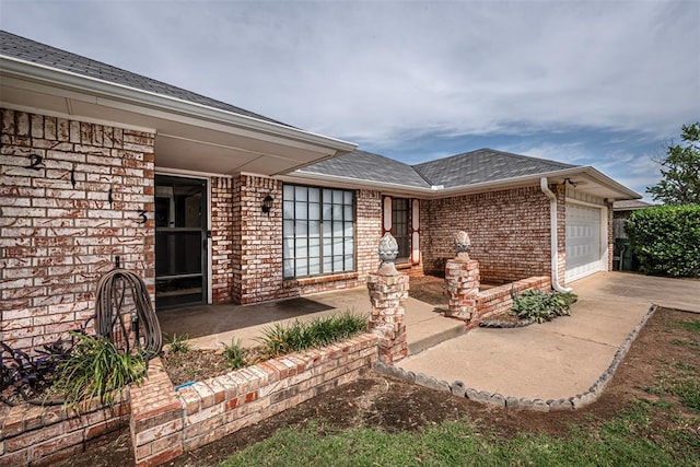 view of exterior entry featuring a garage