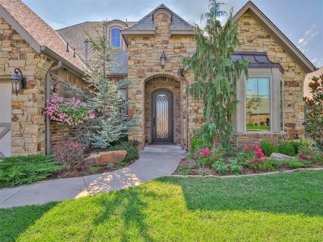 doorway to property with a lawn