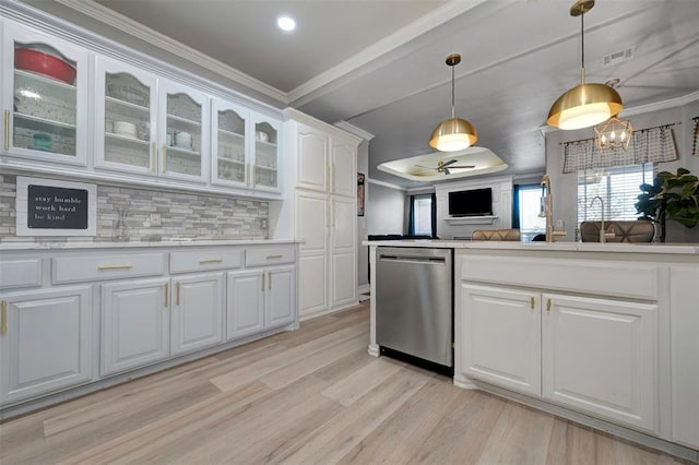 kitchen with stainless steel dishwasher, backsplash, light hardwood / wood-style floors, white cabinets, and ornamental molding