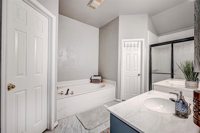 bathroom featuring vanity, vaulted ceiling, and shower with separate bathtub