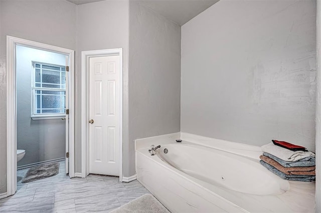 bathroom featuring toilet and a bathing tub