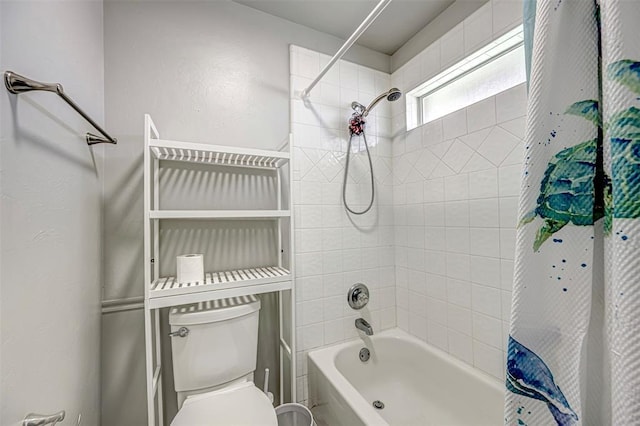 bathroom featuring shower / bath combo and toilet