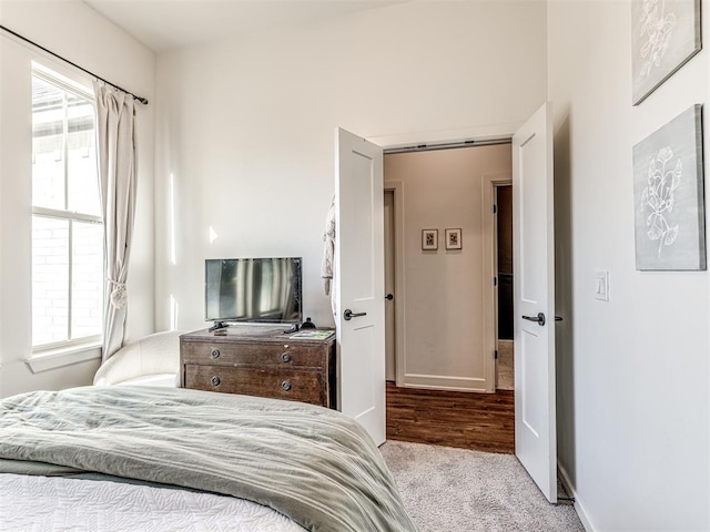 carpeted bedroom featuring multiple windows