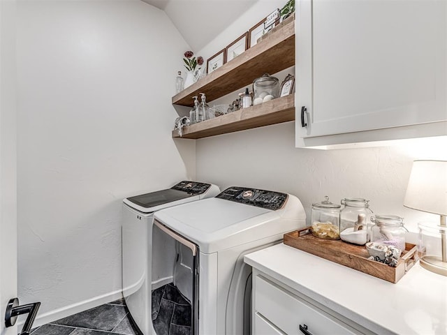 laundry room featuring cabinets and washing machine and clothes dryer