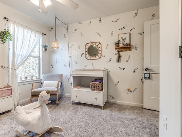 living area featuring carpet floors and ceiling fan