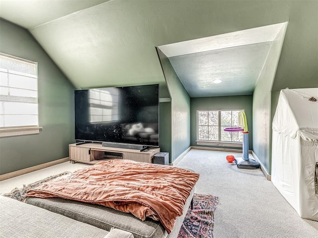 bedroom with light colored carpet and lofted ceiling