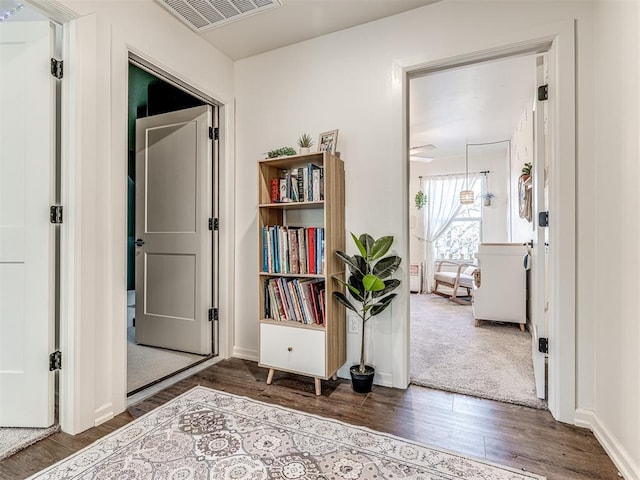 corridor featuring dark wood-type flooring